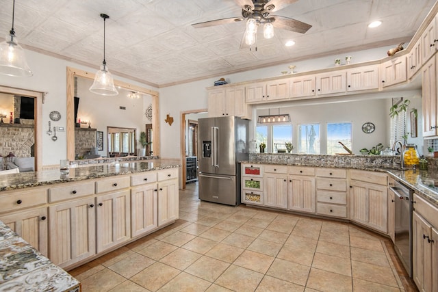 kitchen with pendant lighting, sink, kitchen peninsula, and stainless steel appliances