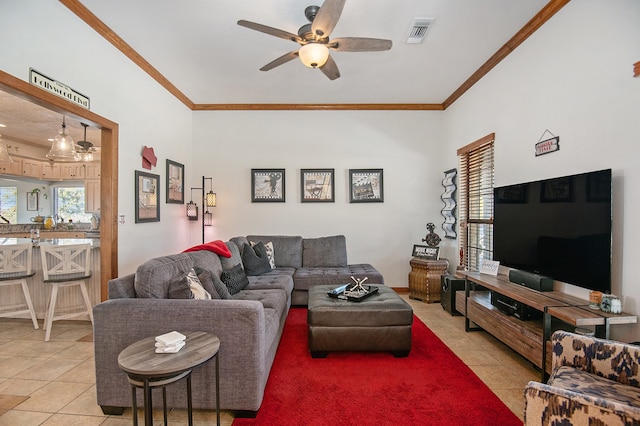 tiled living room featuring crown molding and ceiling fan