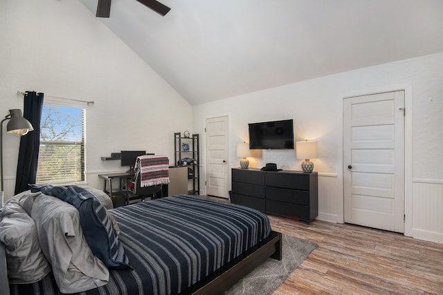 bedroom featuring hardwood / wood-style flooring, ceiling fan, and lofted ceiling