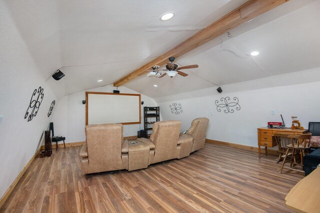 interior space with lofted ceiling with beams, ceiling fan, and wood-type flooring