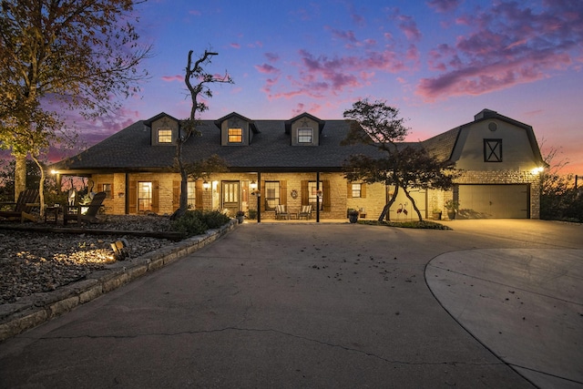 cape cod home with a garage