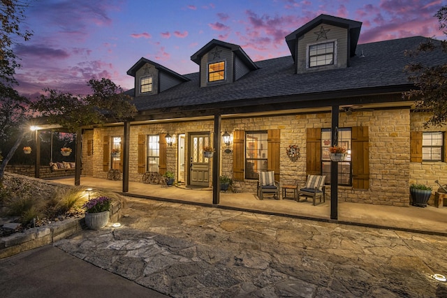 view of back house at dusk