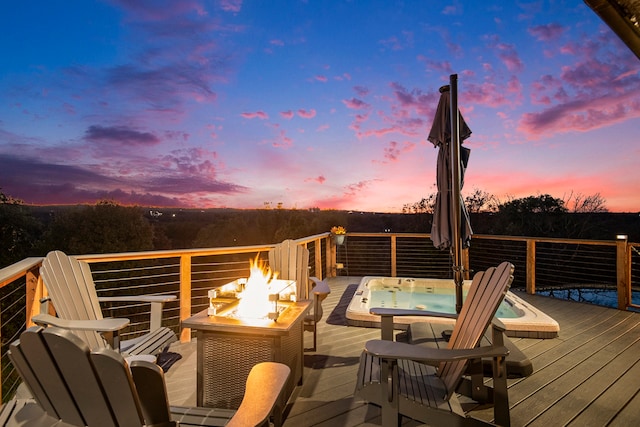 deck at dusk featuring an outdoor fire pit