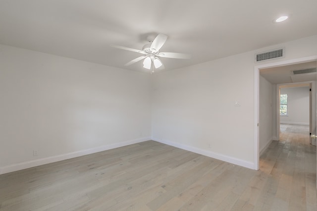 spare room with light hardwood / wood-style flooring and ceiling fan