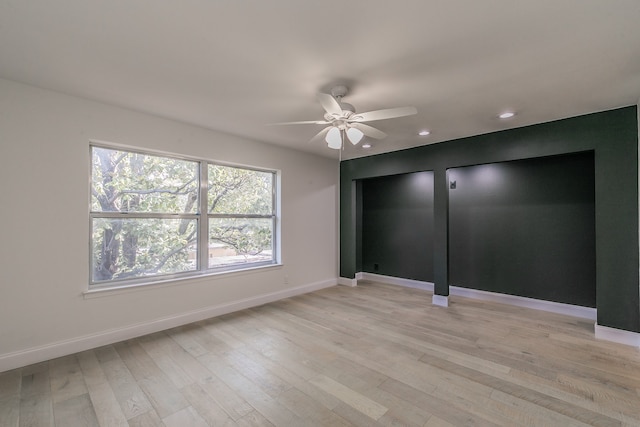 spare room featuring light hardwood / wood-style floors and ceiling fan