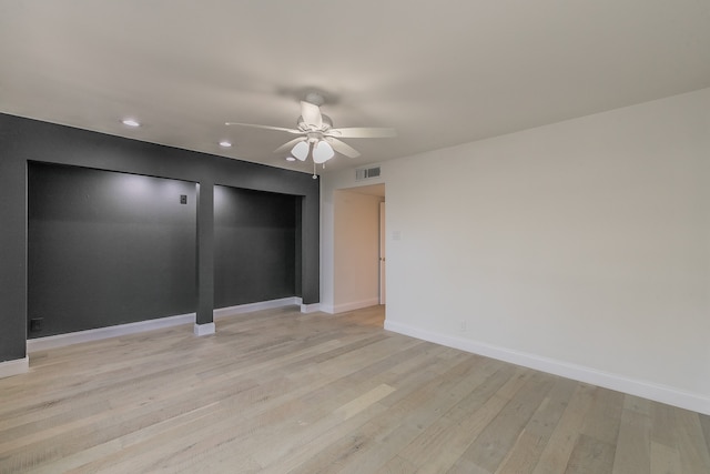 spare room featuring light wood-type flooring and ceiling fan