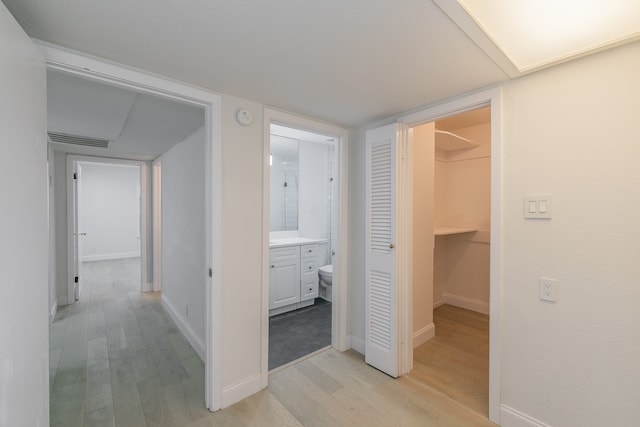 hallway with light hardwood / wood-style flooring