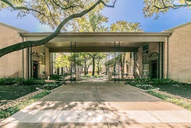 view of parking with a lawn and a carport