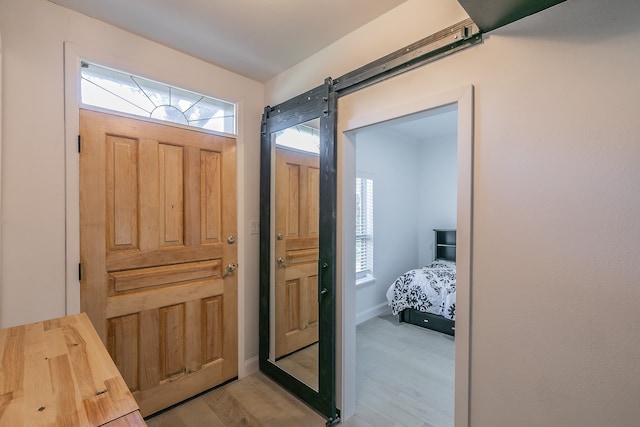 foyer featuring a barn door and light wood-type flooring