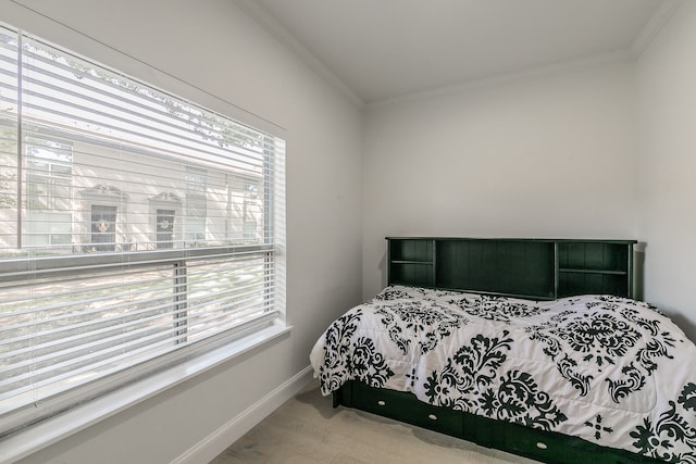 bedroom featuring hardwood / wood-style floors, multiple windows, and ornamental molding