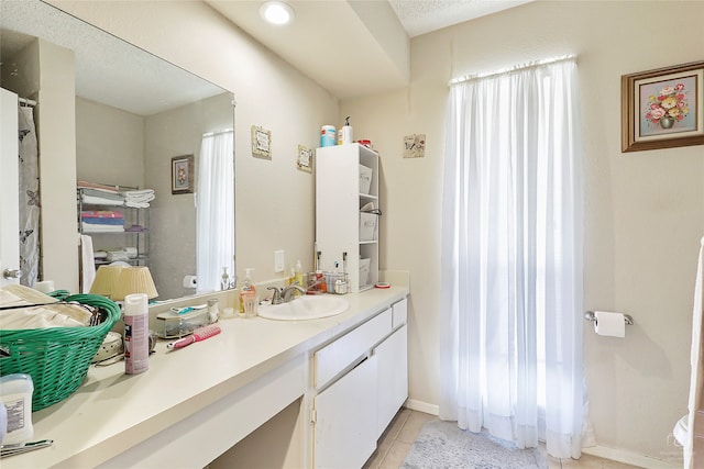 bathroom with tile patterned flooring and vanity