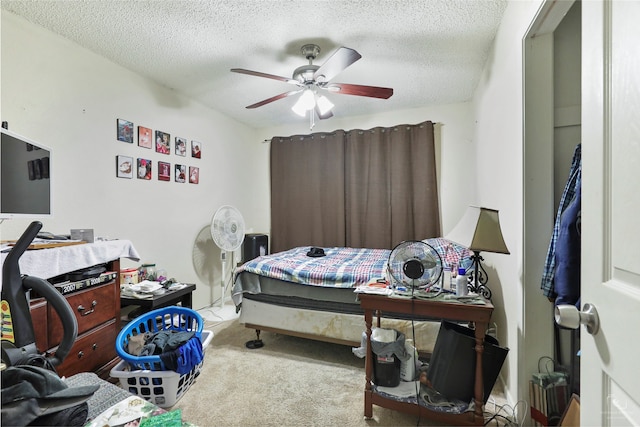 carpeted bedroom with a textured ceiling and ceiling fan