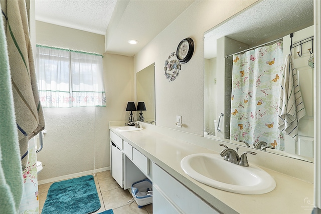 bathroom featuring a textured ceiling, curtained shower, vanity, tile patterned floors, and toilet