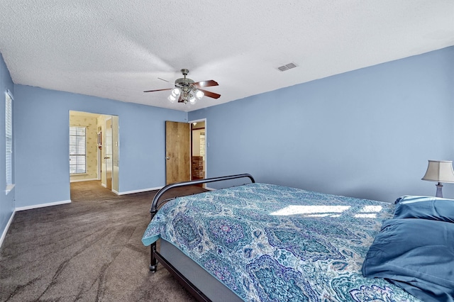 carpeted bedroom featuring a textured ceiling and ceiling fan