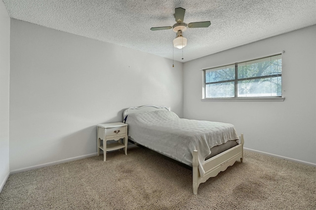 bedroom featuring a textured ceiling, carpet flooring, and ceiling fan