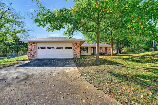 ranch-style home with a front lawn and a garage