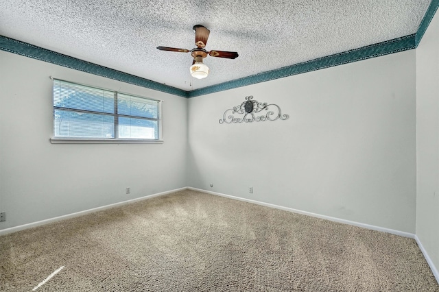 carpeted spare room with a textured ceiling and ceiling fan