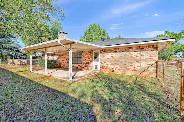 back of property featuring a patio, ceiling fan, and a yard