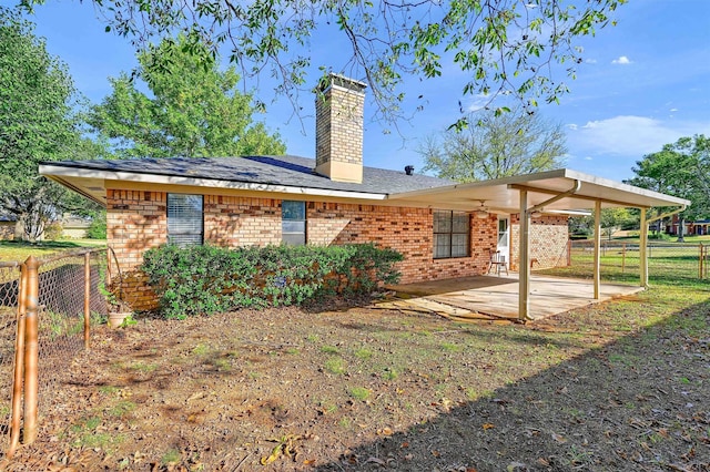 back of house with a patio