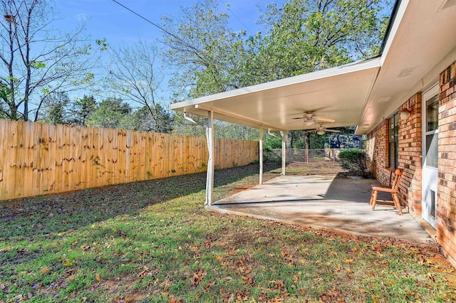 view of yard featuring ceiling fan and a patio