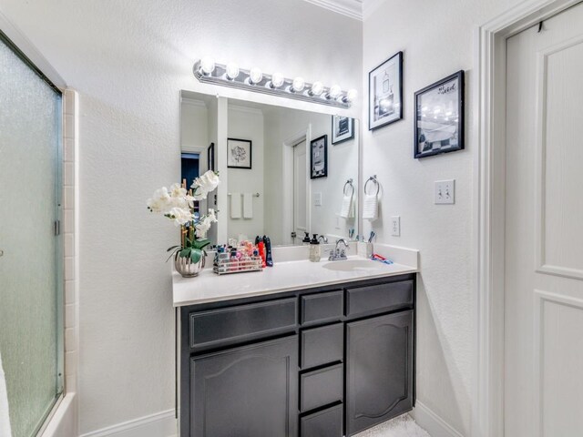 bathroom featuring vanity and combined bath / shower with glass door