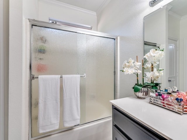 bathroom with bath / shower combo with glass door, vanity, and crown molding