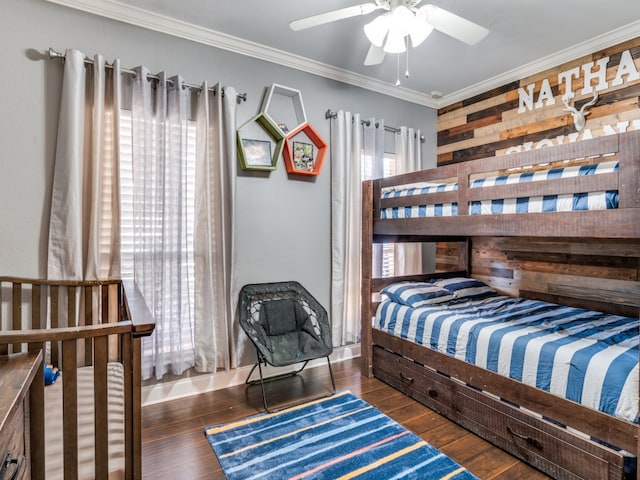 bedroom featuring dark hardwood / wood-style flooring, ceiling fan, and ornamental molding