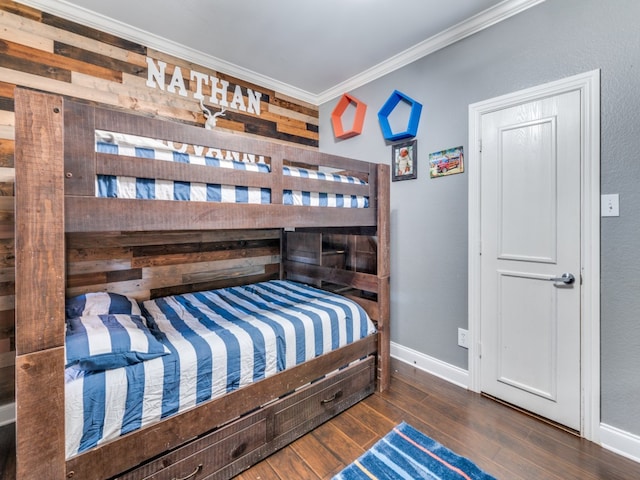 bedroom with ornamental molding and dark hardwood / wood-style floors