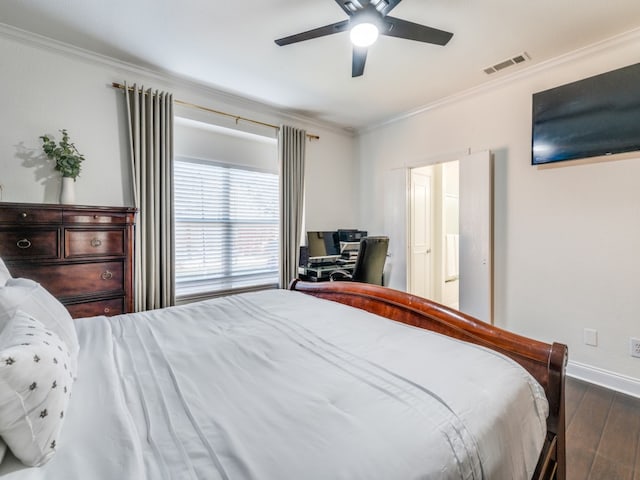 bedroom with dark wood-type flooring, ceiling fan, and crown molding