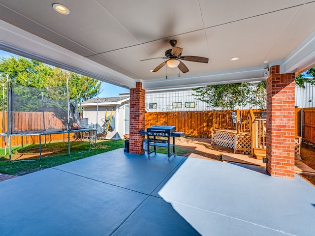 view of patio with a grill, a trampoline, and ceiling fan