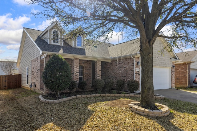 view of front of house with brick siding, driveway, a shingled roof, and an attached garage