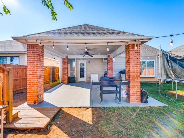 view of patio with area for grilling, a trampoline, and ceiling fan