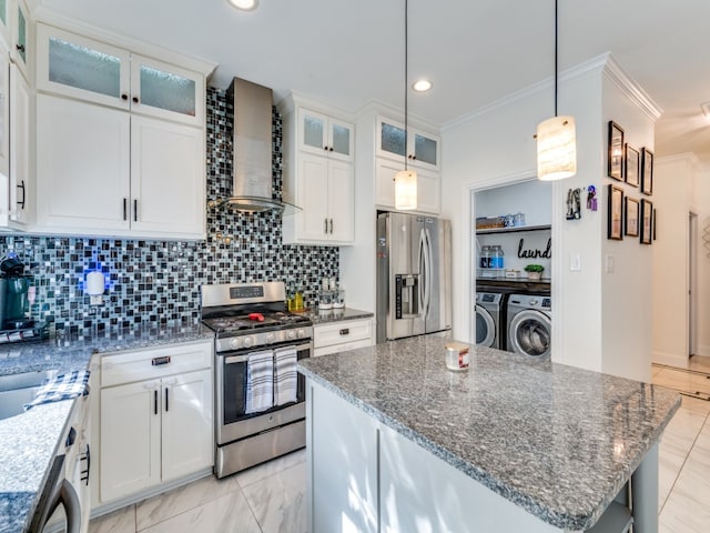 kitchen with white cabinets, separate washer and dryer, appliances with stainless steel finishes, and wall chimney range hood