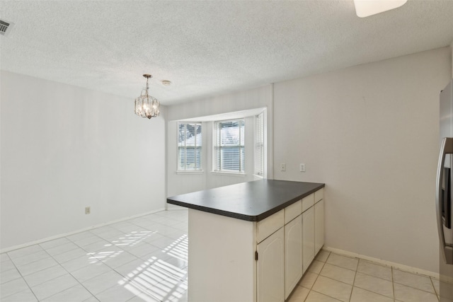 kitchen featuring white cabinets, a chandelier, hanging light fixtures, and kitchen peninsula