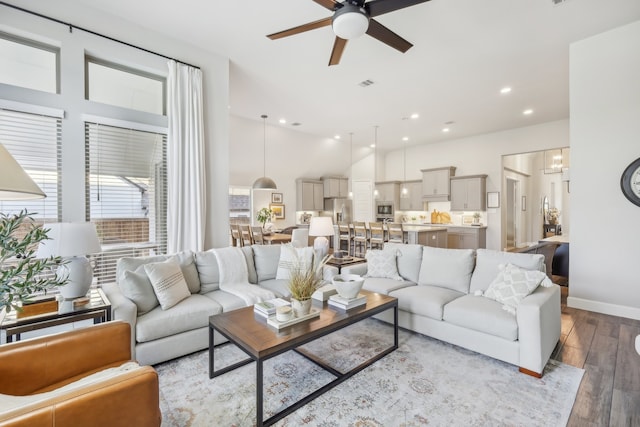 living room featuring ceiling fan and light hardwood / wood-style flooring