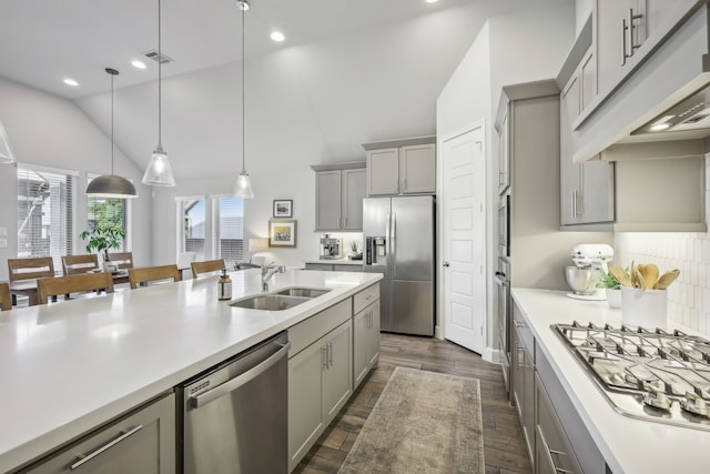 kitchen featuring pendant lighting, gray cabinets, appliances with stainless steel finishes, and sink