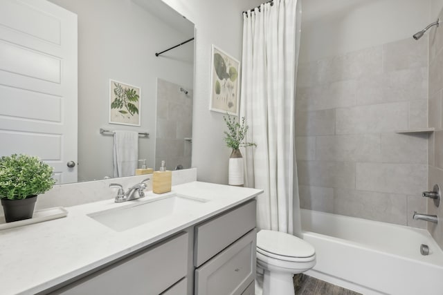 full bathroom with hardwood / wood-style floors, vanity, toilet, and shower / bath combination with curtain