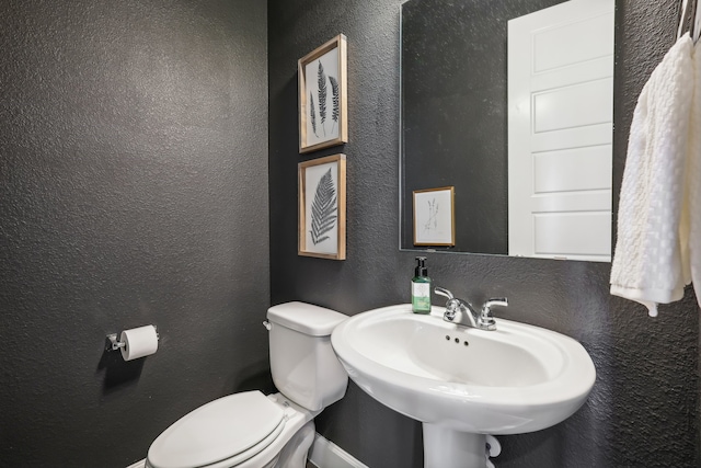 bathroom featuring sink and toilet