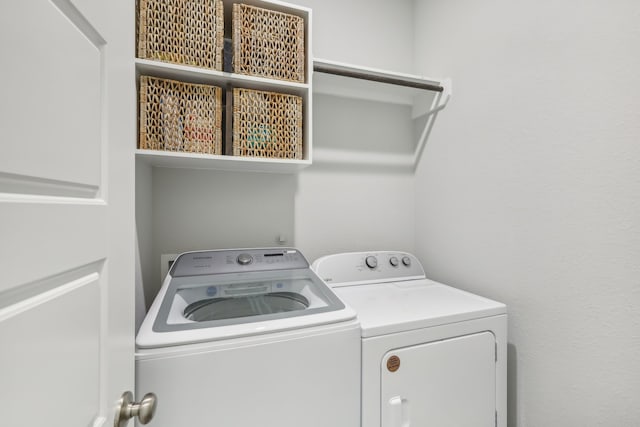 laundry area with washing machine and clothes dryer