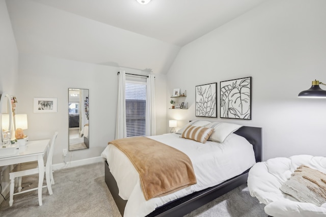 bedroom featuring light colored carpet and lofted ceiling