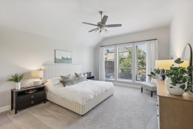 carpeted bedroom featuring vaulted ceiling and ceiling fan