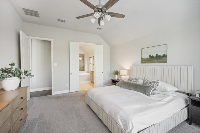 bedroom featuring vaulted ceiling, light carpet, ceiling fan, and ensuite bathroom