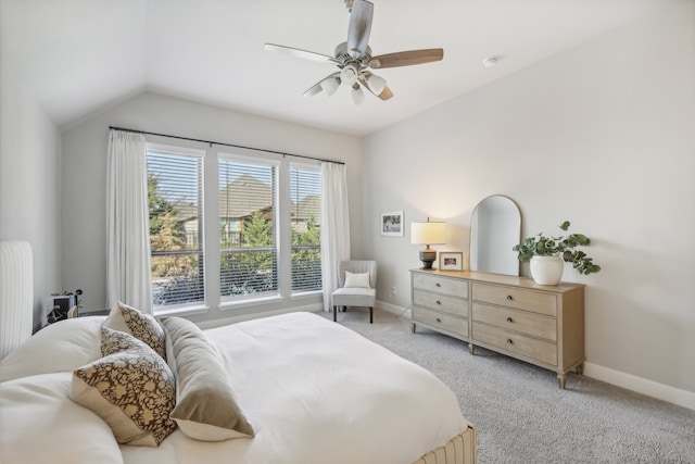 carpeted bedroom featuring ceiling fan and vaulted ceiling