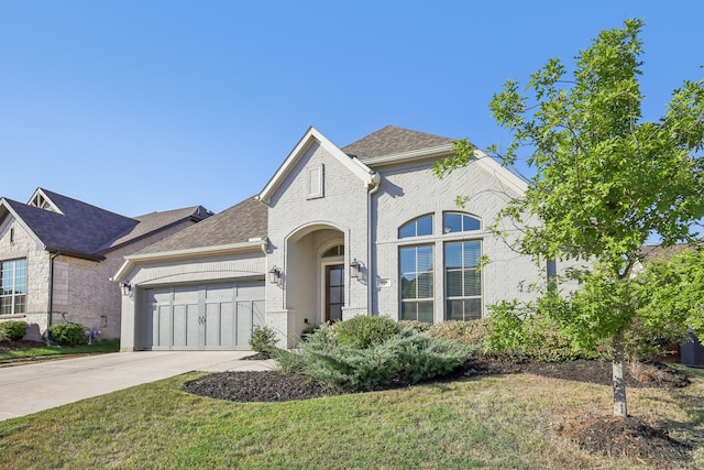 view of front of property featuring a garage and a front yard