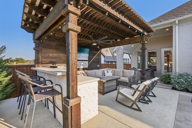 view of patio featuring exterior bar, a pergola, and an outdoor living space