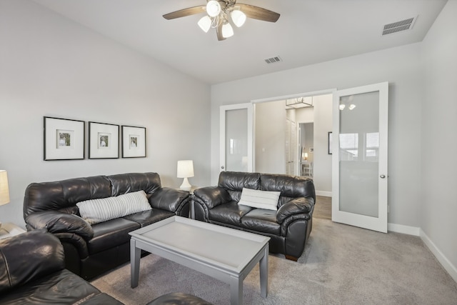 living room featuring french doors, light colored carpet, and ceiling fan