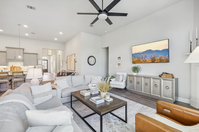 living room with hardwood / wood-style floors and ceiling fan