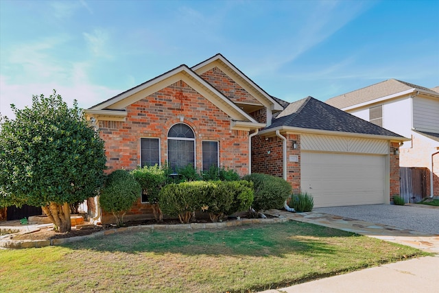 view of front of house with a garage and a front lawn