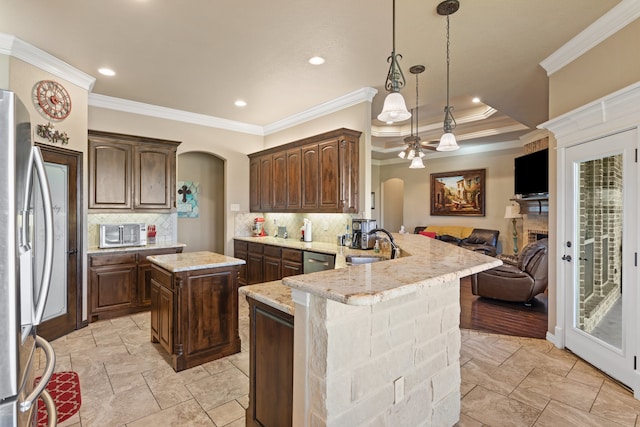 kitchen with decorative backsplash, kitchen peninsula, ornamental molding, and appliances with stainless steel finishes