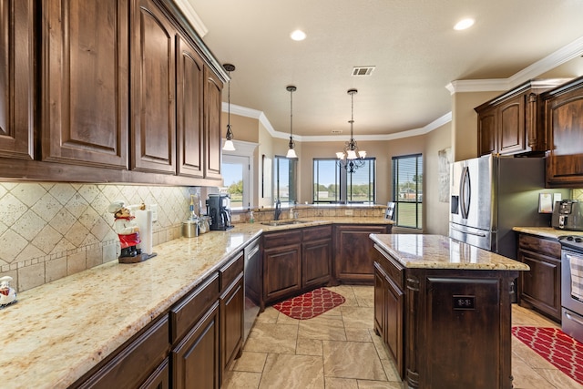 kitchen featuring light stone counters, stainless steel appliances, crown molding, sink, and an inviting chandelier